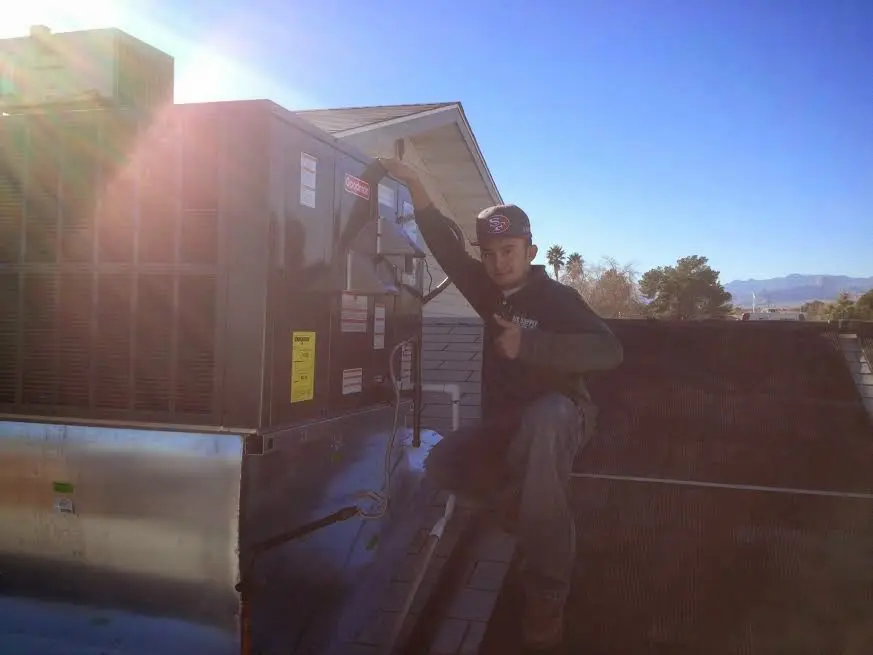 HVAC technician performing HVAC Inspection on a rooftop unit in Woodruff